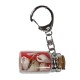 Porte clés bouteille avec sable rouge et coquillages